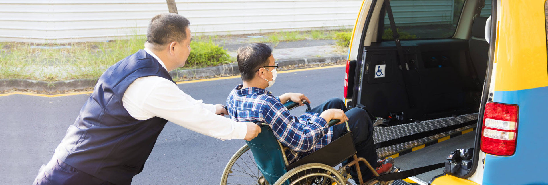 man on a wheelchair entering the back of a van